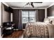 Bedroom featuring wood floors, a large window, and a ceiling fan at 1228 Knapps Ct, Greenwood, IN 46142