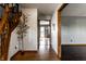 View of the home's entryway featuring hardwood floors, decorative trim, and a glimpse into other rooms at 1228 Knapps Ct, Greenwood, IN 46142