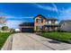 Traditional two-story home featuring brick accents, vinyl siding, and a driveway leading to an attached garage at 1228 Knapps Ct, Greenwood, IN 46142