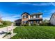 Charming two-story home boasts brick and vinyl siding, a well-manicured lawn, and an inviting front porch at 1228 Knapps Ct, Greenwood, IN 46142