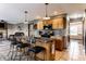 Open kitchen with granite island, stainless appliances, tile flooring, and seamless flow into the living room at 1228 Knapps Ct, Greenwood, IN 46142