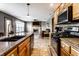 Kitchen showcasing stainless steel appliances, granite countertops, a gas cooktop, and warm wooden cabinets at 1228 Knapps Ct, Greenwood, IN 46142