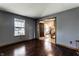 Inviting living room with dark wood floors, a window with blinds, and a view into another room at 1228 Knapps Ct, Greenwood, IN 46142