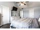 Bright bedroom with dresser, mirror and white flower arrangement; television on the wall at 1228 Knapps Ct, Greenwood, IN 46142