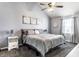 Bright bedroom with a vaulted ceiling, ceiling fan, plush carpet and a comfortable queen sized bed at 1228 Knapps Ct, Greenwood, IN 46142