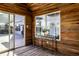 Inviting porch with wood paneled walls, sliding glass door, and large window showcasing the outdoor view at 1228 Knapps Ct, Greenwood, IN 46142