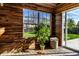 Relaxing porch featuring wood paneled walls, sliding glass door, and a lush green backyard view at 1228 Knapps Ct, Greenwood, IN 46142