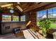 Bright sunroom featuring a relaxing hot tub, wood paneled walls, and multiple windows with a beautiful view at 1228 Knapps Ct, Greenwood, IN 46142