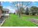 Lush backyard with manicured lawn, mature trees, and tasteful landscaping at 13225 Snow Owl Dr, Carmel, IN 46033