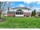 Expansive backyard features a screened porch and brick-and-siding exterior at 13225 Snow Owl Dr, Carmel, IN 46033