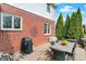 Cozy backyard patio with outdoor seating, barbecue grill, and well-manicured landscaping with some trees at 13225 Snow Owl Dr, Carmel, IN 46033