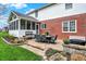 Brick patio with dining set, grill, and landscaping, perfect for outdoor entertaining and relaxation at 13225 Snow Owl Dr, Carmel, IN 46033
