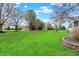 Green backyard featuring manicured lawn, and mature trees at 13225 Snow Owl Dr, Carmel, IN 46033