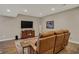 Finished basement with brown leather sofa, TV, and hardwood floors at 13225 Snow Owl Dr, Carmel, IN 46033