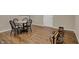 Finished basement with hardwood floors, table with chairs and rowing machine at 13225 Snow Owl Dr, Carmel, IN 46033