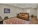 Finished basement with brown leather sofa and hardwood floors at 13225 Snow Owl Dr, Carmel, IN 46033