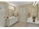 Bathroom features a double vanity, framed mirrors, and neutral tile flooring at 13225 Snow Owl Dr, Carmel, IN 46033