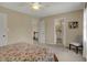 Neutral bedroom featuring carpet, ceiling fan, and a door to the bathroom at 13225 Snow Owl Dr, Carmel, IN 46033
