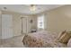 Neutral bedroom featuring carpet, ceiling fan, and a window for natural light at 13225 Snow Owl Dr, Carmel, IN 46033
