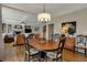Comfortable dining area adjacent to the living room showcasing hardwood floors and natural lighting at 13225 Snow Owl Dr, Carmel, IN 46033