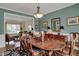 Elegant dining room features hardwood floors, chandelier, and view of the living area at 13225 Snow Owl Dr, Carmel, IN 46033