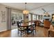Light-filled dining area with wooden table, chairs, and sliding glass doors to the outside patio at 13225 Snow Owl Dr, Carmel, IN 46033