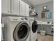 Bright laundry room includes a washer, dryer, and plenty of cabinet space at 13225 Snow Owl Dr, Carmel, IN 46033