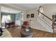 Inviting living room features hardwood floors, staircase, and views of dining area at 13225 Snow Owl Dr, Carmel, IN 46033