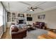 Comfortable living room with a brick fireplace, built-in shelving, hardwood floors, and ample seating at 13225 Snow Owl Dr, Carmel, IN 46033