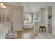 Well-lit main bathroom with a walk-in shower and soaking tub by the window at 13225 Snow Owl Dr, Carmel, IN 46033