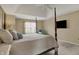 Relaxing main bedroom features a four poster bed, tray ceiling and accent chair at 13225 Snow Owl Dr, Carmel, IN 46033