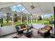 Inviting screened-in porch with comfortable seating and scenic views of the landscaped backyard and mature trees at 13225 Snow Owl Dr, Carmel, IN 46033