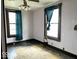 Bedroom featuring hardwood floors, two windows, and outdated lighting fixture, awaiting renovation at 1325 S Hackley St, Muncie, IN 47302