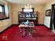 Dining room with classic hutch and dining table with decor set, vintage chandelier, and textured wallpaper at 1325 S Hackley St, Muncie, IN 47302