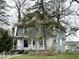 Charming two-story home with a covered front porch and mature trees in a residential neighborhood at 1325 S Hackley St, Muncie, IN 47302