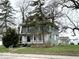 Charming two-story home with a covered front porch and mature trees in a residential neighborhood at 1325 S Hackley St, Muncie, IN 47302