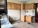 Kitchen features rustic cabinetry, laminate countertops, and is awaiting renovation at 1325 S Hackley St, Muncie, IN 47302