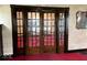 Elegant living room with vintage glass paneled doors, textured walls, and hardwood trim at 1325 S Hackley St, Muncie, IN 47302