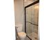 Modern bathroom with glass shower, toilet, and black fixtures for a sleek, clean look at 150 E Troy Ave, Indianapolis, IN 46225