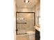 Modern bathroom featuring a glass shower, toilet, and vanity with natural light from a window at 150 E Troy Ave, Indianapolis, IN 46225