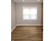 Well-lit bedroom showcasing wood-look floors and a window with bright natural light at 150 E Troy Ave, Indianapolis, IN 46225