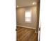 Bright bedroom featuring hardwood floors and a large window with blinds at 150 E Troy Ave, Indianapolis, IN 46225