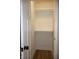 Walk-in closet with white shelving and hanging rods providing ample storage space at 150 E Troy Ave, Indianapolis, IN 46225
