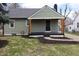 Charming home featuring a cozy covered porch, dark accents, and a well-maintained front yard at 150 E Troy Ave, Indianapolis, IN 46225