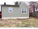 View of home's exterior with neat, well-maintained siding and yard at 150 E Troy Ave, Indianapolis, IN 46225