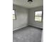 Minimalist bedroom with gray carpet, neutral walls, and natural light from two windows at 1502 Saint John S Ct, Beech Grove, IN 46107