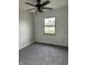 Cozy bedroom with gray carpet, painted brick wall, and modern ceiling fan at 1502 Saint John S Ct, Beech Grove, IN 46107
