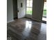 Inviting entryway featuring glossy light-colored wood flooring, gray walls, and a storm door at 1502 Saint John S Ct, Beech Grove, IN 46107