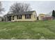 Quaint single-story home with large front lawn and detached garage at 1502 Saint John S Ct, Beech Grove, IN 46107