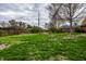 Large backyard with green lawn, garden area, mature trees and wood fence at 1550 Renee Dr, Plainfield, IN 46168